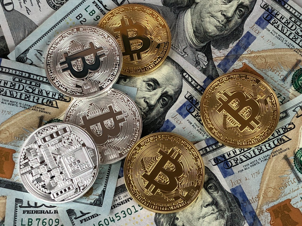 our-value Close-up of bitcoins and US dollar bills symbolizing modern finance and cryptocurrency.